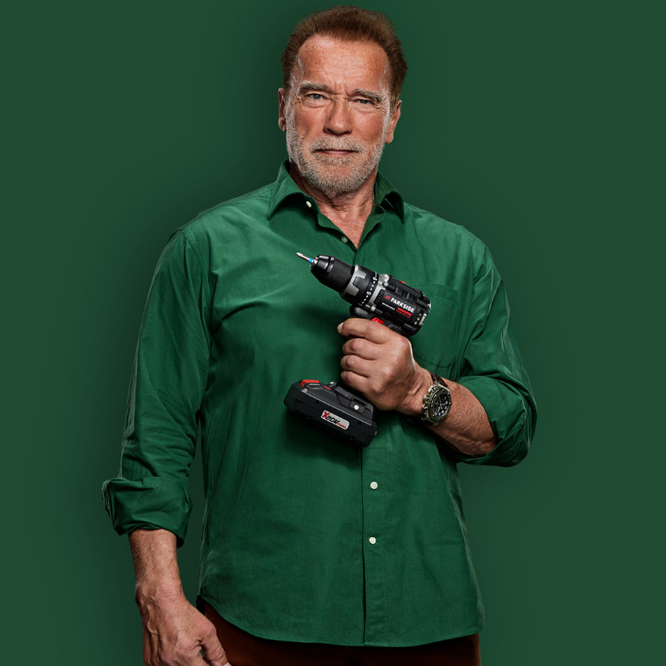 Arnold Schwarzenegger holding a Parkside drill.